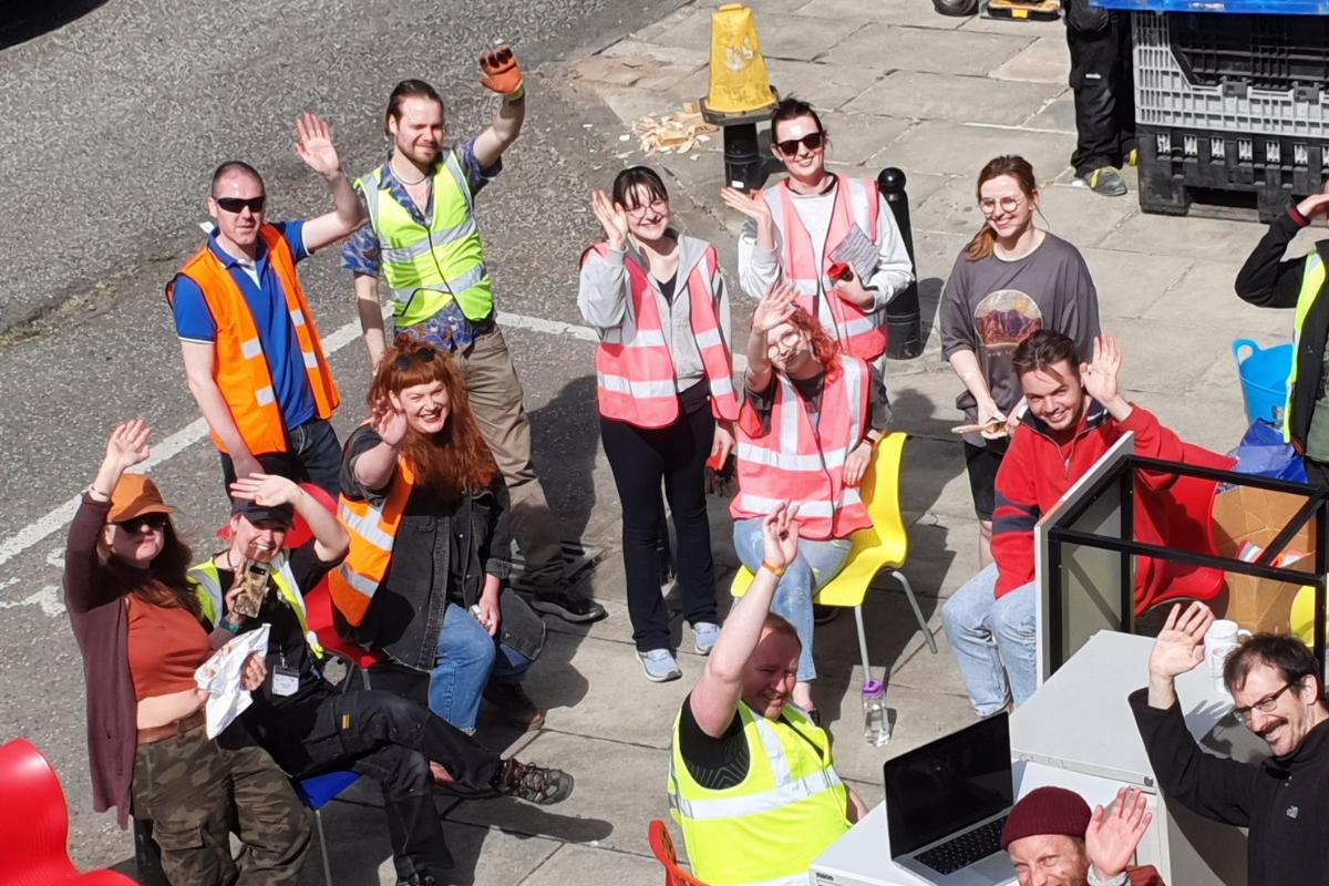Hidden Door volunteers waving and smiling